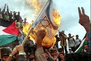 Ikhwanul Muslimin (Muslim Brotherhood) protestors burning the Israeli flag